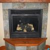 Before - manufactured gas fireplace glass front and vents.